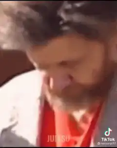 Man looking down then up confused