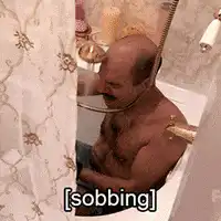 man sobbing in shower
