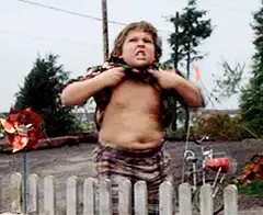 Boy struggling to put on shirt