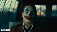 Joker laughing in police car