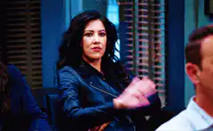 Two women high five in an office