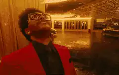 The Weeknd laughing in the rain