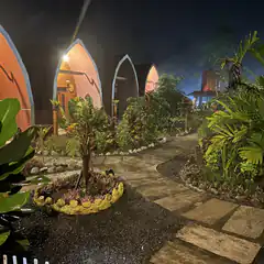 Rainy night at a tropical resort with arched cabins