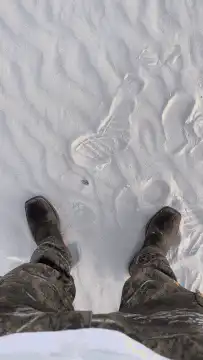 First person view of white sand dunes at sunset