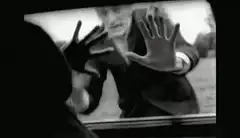 Zombie man pressing hands on car window