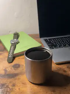 Coffee cup on a desk with laptop