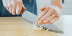 chopping garlic with a knife