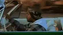 Man struggling to close car window