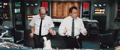two men dancing in a control room