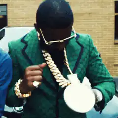 Man in green suit with giant gold chain