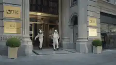 People in animal masks exit building