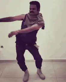 Man in bandana dancing energetically