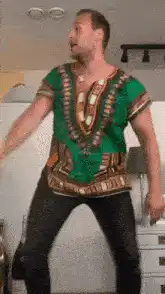 Man in green dashiki dancing