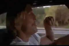 Dustin Hoffman driving and singing
