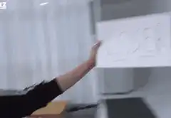 Person holding loser sign