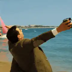 Mr. Bean taking a selfie on the beach
