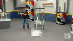 Man holds black square over water jet