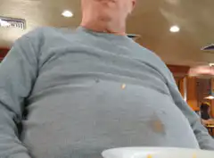 Man eating messily in restaurant
