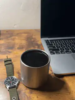 coffee cup and laptop on desk