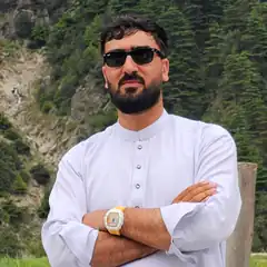 Man in white kurta with sunglasses and gold watch