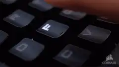 Finger pressing keyboard key with changing backlight