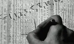 Hand writing numbers on stock ticker