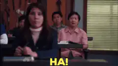 Jerry and Britta laughing in class