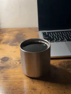 metal cup on wooden desk