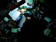 Overhead view of person at messy computer desk