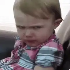 Toddler eating with angry face