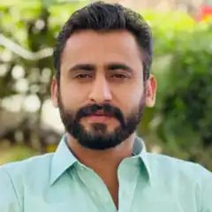 Man with beard in green shirt