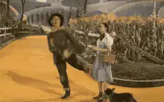 Scarecrow dancing on yellow brick road