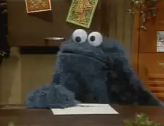 Cookie Monster reading a letter