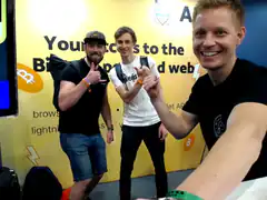 Three men posing at Bitcoin event