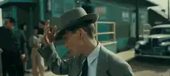 Man rubbing eyes then smirking