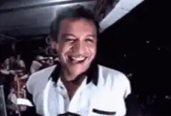 Man laughing then winking