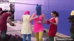 people in colorful costumes dancing on a dock