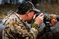man in camo taking photo