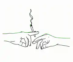 Hand holding a lit cigarette