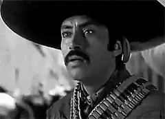 El Mariachi looks at woman's legs