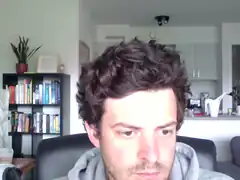 man with curly hair looking down