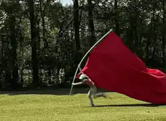 Person running with large red flag