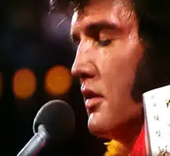 Elvis Presley singing into a microphone