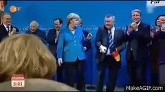 Angela Merkel receives flag and walks off stage