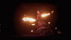 Fire dancer spinning with flaming props