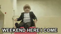 Toddler in suit on red wagon