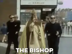 The Bishop walking with bodyguards