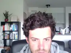 Man with curly hair looking down