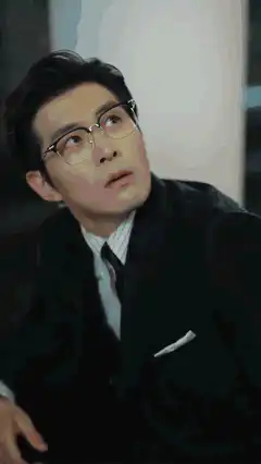 Man in glasses looks up at doctor
