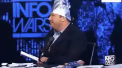 Alex Jones wearing a tinfoil hat